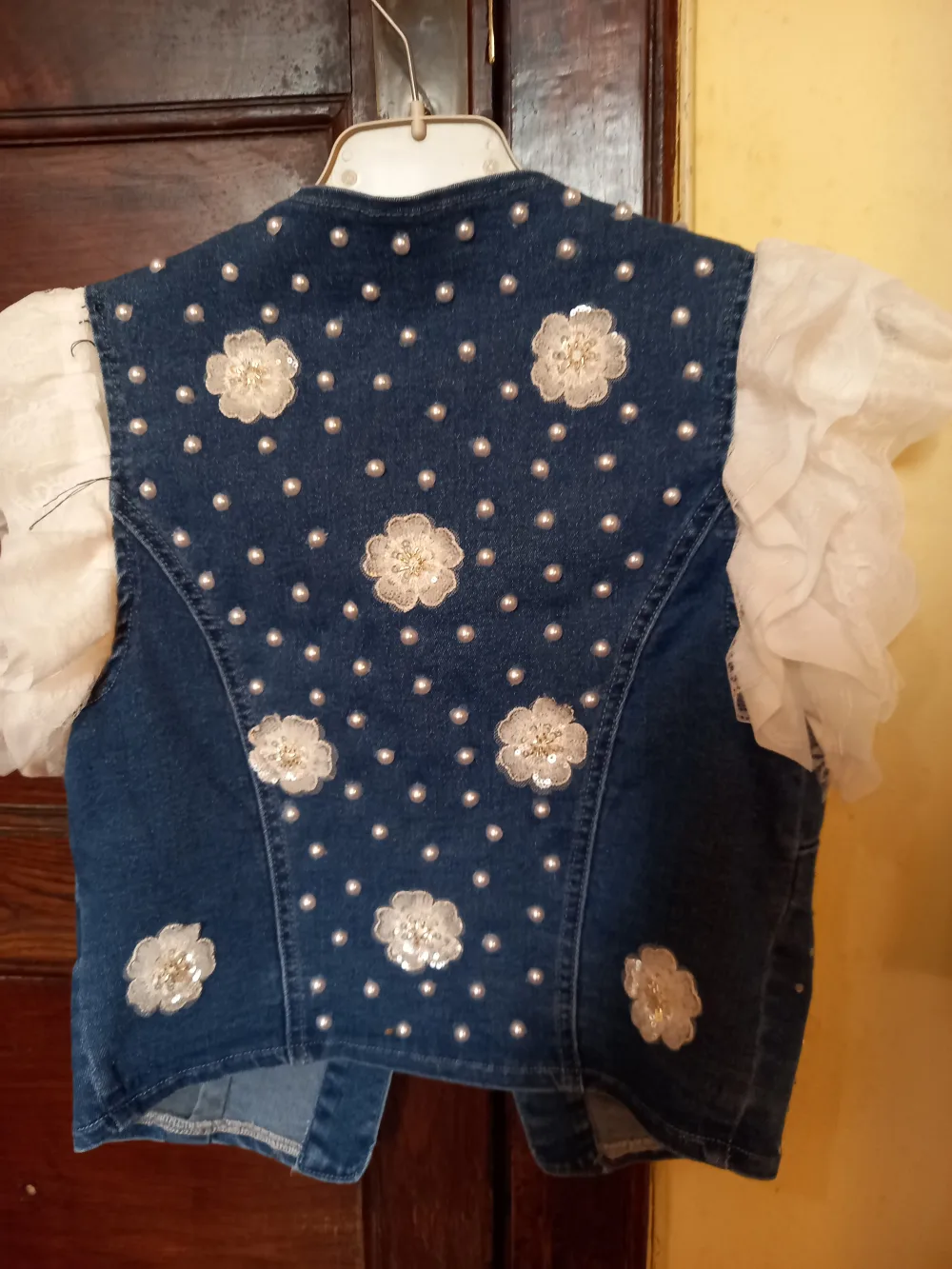 Chaleco vaquero con volantes y flores de perlas